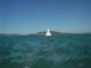 Sailboat against shoreline